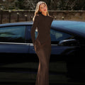 High-neck, fitted, padded-shoulder, long-sleeved, sophisticated dark-toned dress
